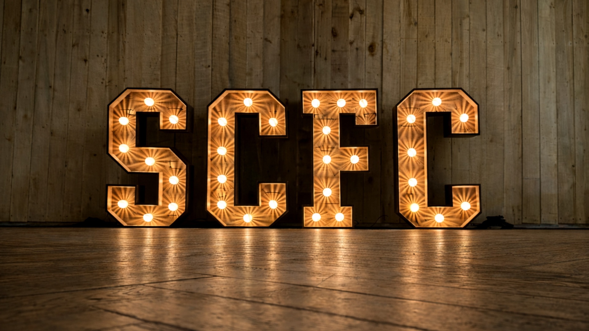 Large illuminated STC letters at a corporate event